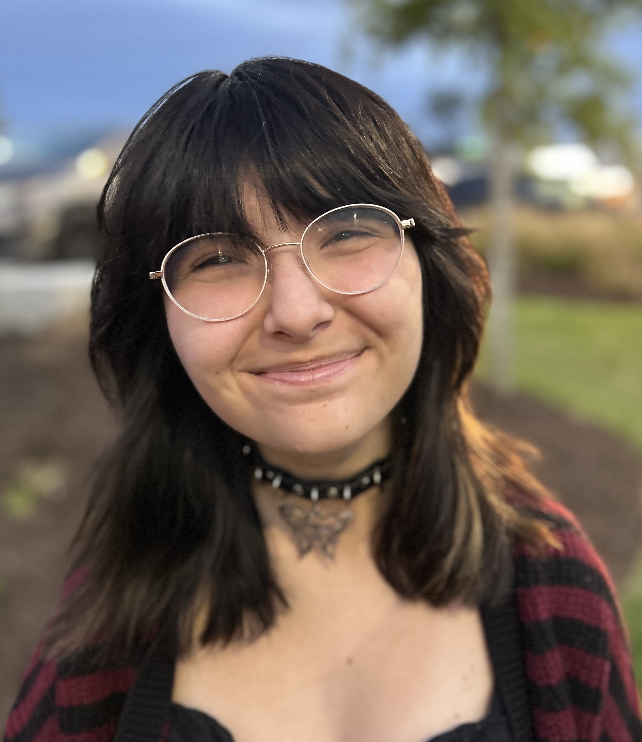 Young feminine person, smiling at camera