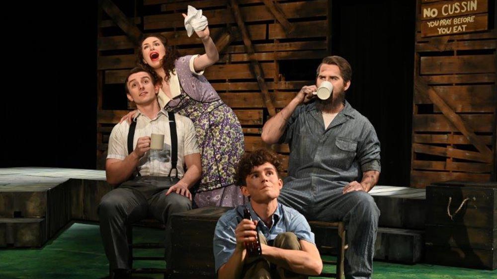 A family of three men and a women, dressed in 1930's dust bowl era clothing